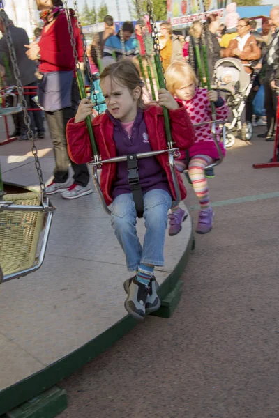 Child on kirtag in kettenkarusell, ringelspiel, ka — Stock Photo, Image