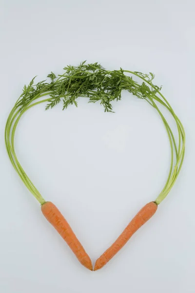 Fresh carrots in heart shape — Stock Photo, Image