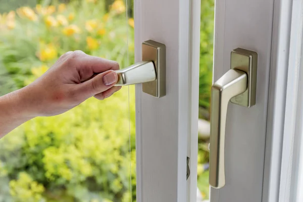 Woman opens window to air — Stock Photo, Image