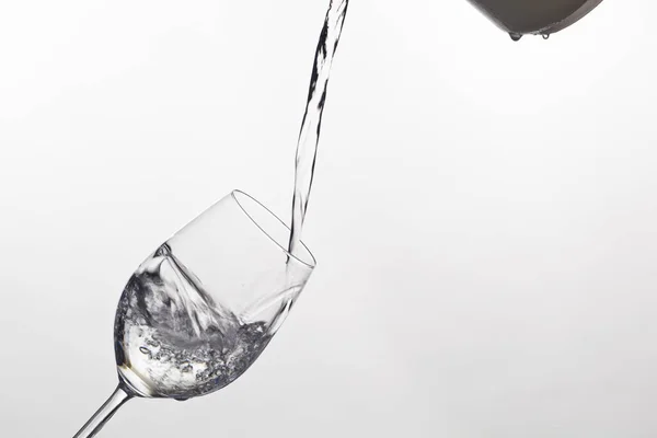 Water is poured into a glass of water — Stock Photo, Image