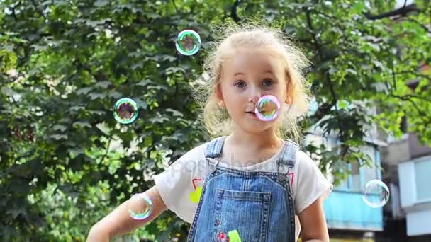 Niña soplando burbujas de jabón — Vídeo de stock