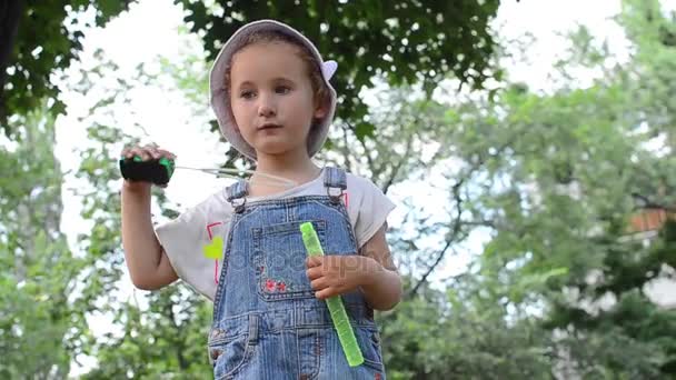 Little girl blowing soap bubbles — Stock Video