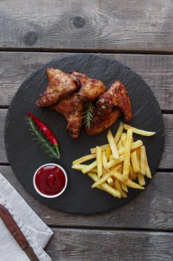 Kızarmış tavuk kanatlı patates kızartması ve sos kavrulmuş