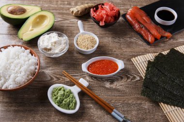 ahşap bir masa üzerinde suşi için malzemeler