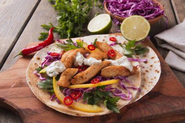 Tavuk salata sebze ve sos bir Meksikalı tortilla Taco üzerinde