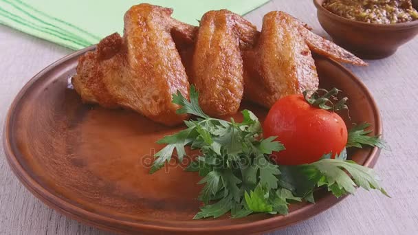 Fried chicken wing falls on a plate slow motion footage — Stock Video