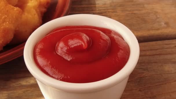 Chicken nuggets in breading are dipped in tomato sauce — Stock Video