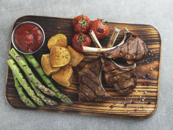 Roasted Rack Lamb Chops Wooden Board Red Sauce Potatoes Tomatoes — Stock Photo, Image