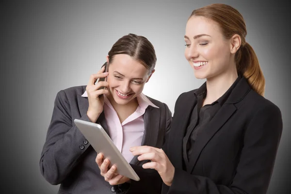 Businesswoman with tablet and phone — Stock Photo, Image