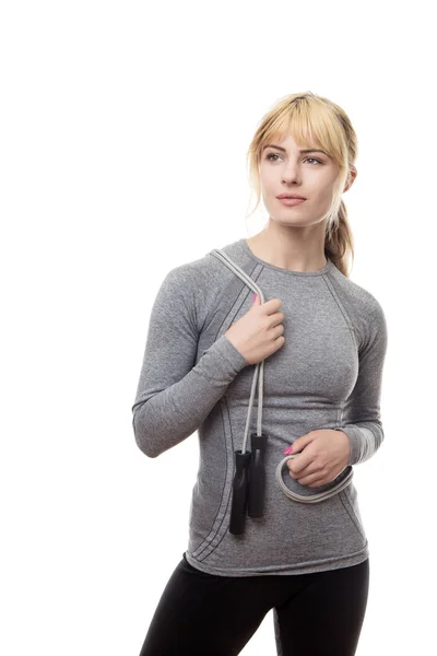 Standing blonde woman with a skipping rope — Stock Photo, Image