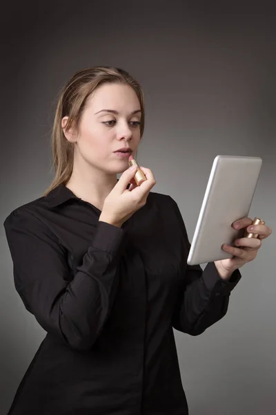 Joven Mujer Negocios Que Pone Lápiz Labial Usando Una Tableta — Foto de Stock