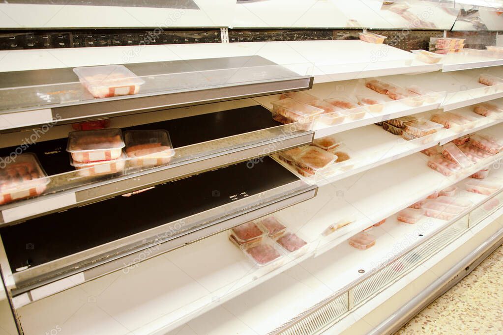 large supermarket selling out of food down the meat aisle