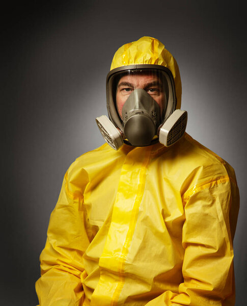 portairt of a single man wearing a protective hazmat suitshot in the studio on a background