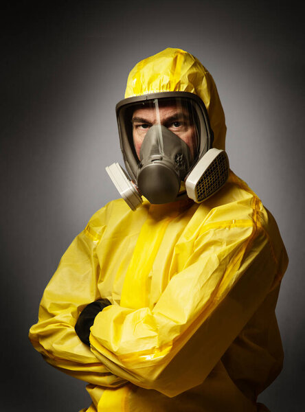 portairt of a single man wearing a protective hazmat suitshot in the studio on a background