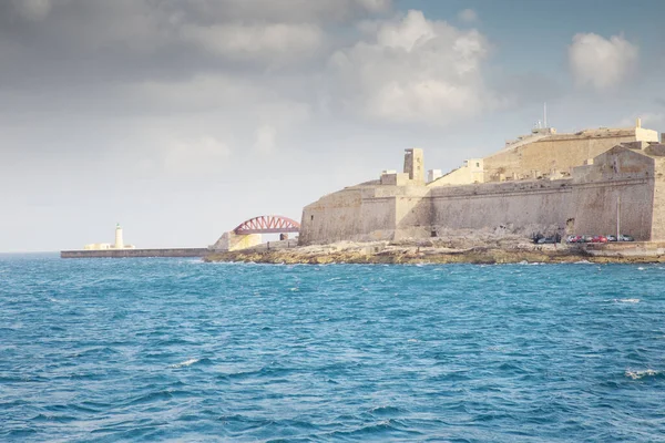 seascape of Valletta breakwater lighthouse and bridge