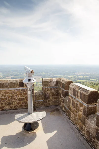 telescope at the top of a tower in surrey overlooking countryside and heathland of england