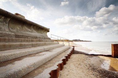 sea barrier defences at happisburgh beach in england clipart