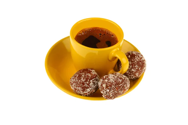Cup of coffee with chocolate balls isolated on white — Stock Photo, Image