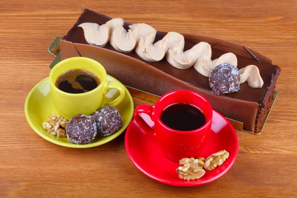 Chocolate cake with two cup of coffee and chocolate balls — Stock Photo, Image