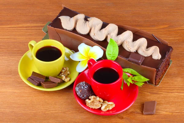 Chocolate cake with two cup of coffee and chocolate balls — Stock Photo, Image