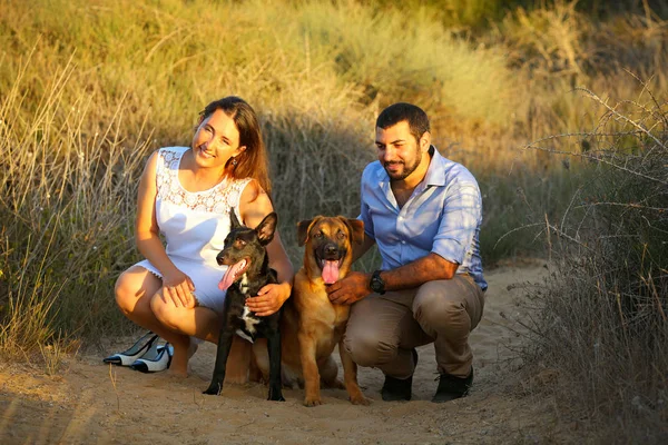 Young couple with two dogs — Stock Photo, Image