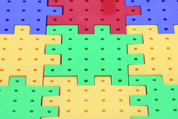 Colorful plastic puzzle — Stock Photo, Image