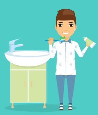 Bir çocuk lavaboya duruyor. Bir diş fırçası ve macunu elinde.