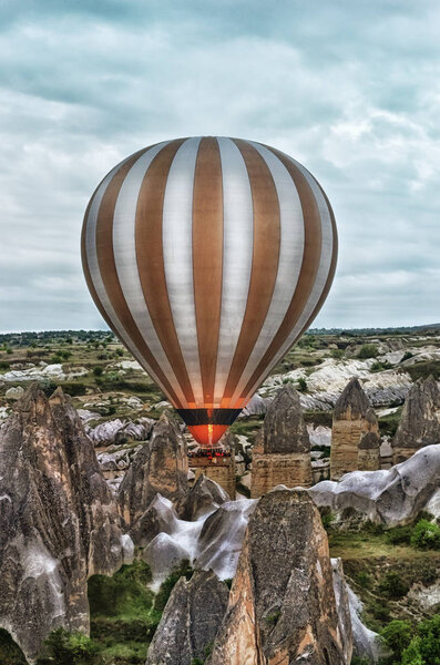 Hot air balloons over mountains 