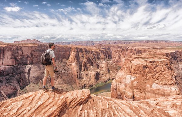 traveler looks at Horseshoe Bend in Utah, USA