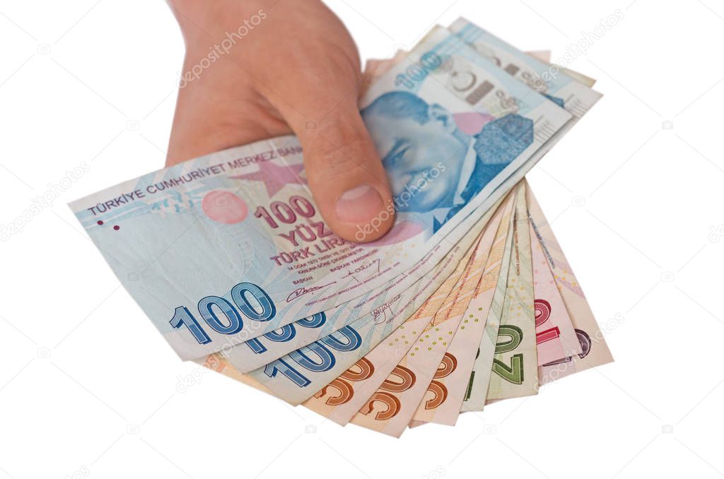 Hand holding  of Turkish Lira Currency, on a white background.