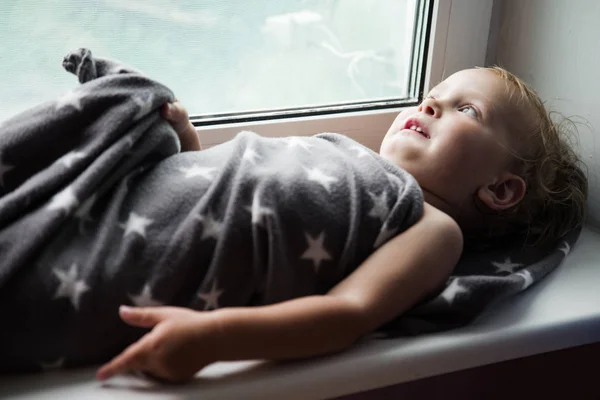 The boy on a windowsill — Stock Photo, Image