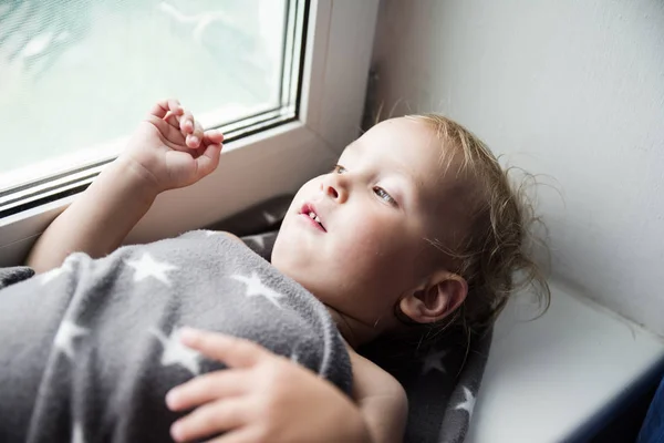 The boy on a windowsill — Stock Photo, Image