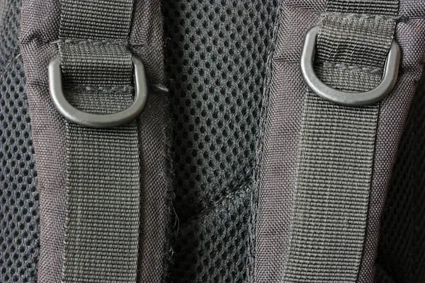 Black straps of a backpack for hiking