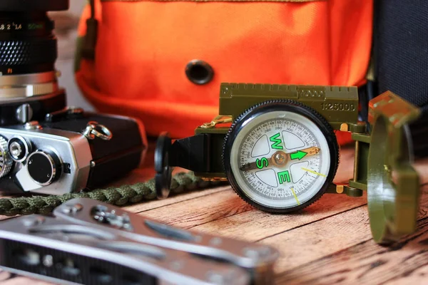 A compass and a multitool for a hike