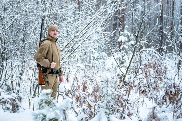 Охотник в камуфляжной одежде зимой — стоковое фото