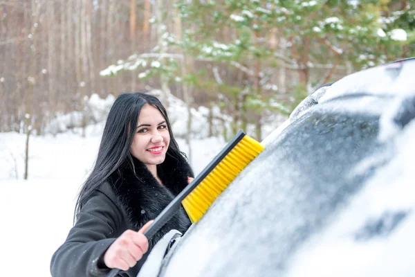 Mulher limpando carro da neve com escova. Transporte, inverno , — Fotografia de Stock