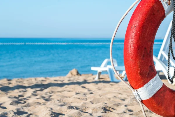 life preserver on a background of the sandy beach and the sea