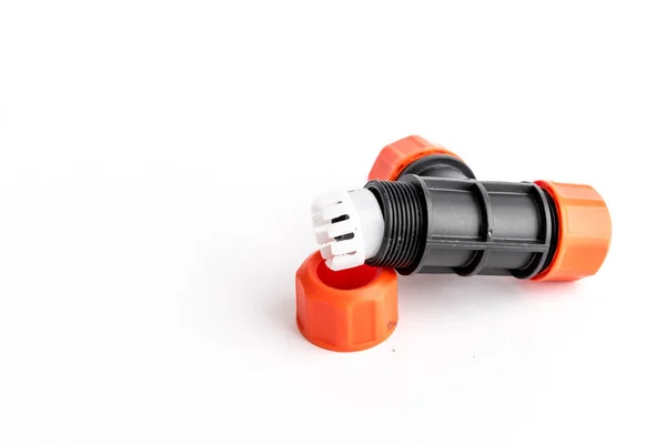 Orange garden water hose nozzle and connectors isolated on white