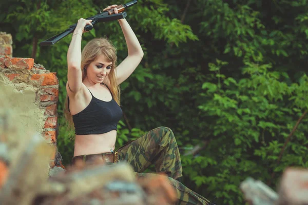 Porträt eines schönen Mädchens in Tarnung mit einem Gewehr in der Hand — Stockfoto