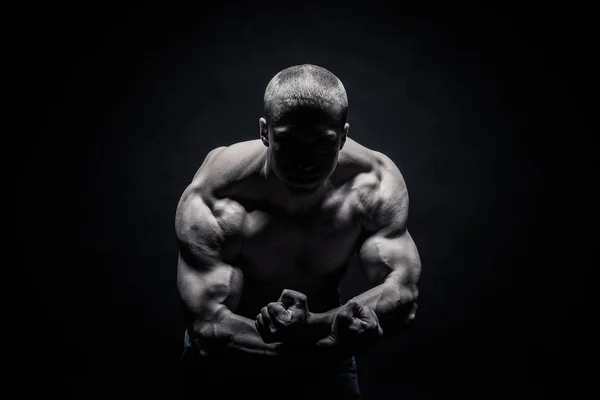 Retrato de un culturista masculino, tensando los músculos en pose deportiva — Foto de Stock