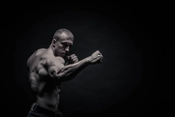 Portrait of a male bodybuilder on a black background isolated. m — Stock Photo, Image