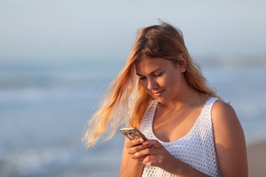 Portrait of a young beautiful girl on a background of the sea.