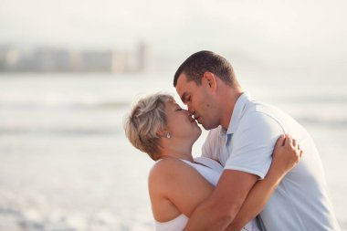 Portrait of a happy lovers husband and wife. Couple walks along the sea at sunrise