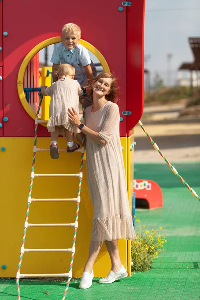 Portrait of happy mothers with children. The family walks on the playground in the summer — ストック写真