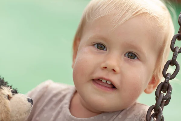 Portrait of a pretty little girl on a green background — Stock Photo, Image