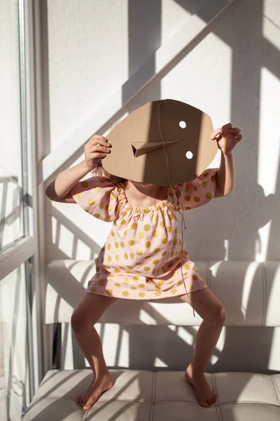 Portrait Girl Child Hides His Face Cardboard Mask Indoor — Stock Photo, Image