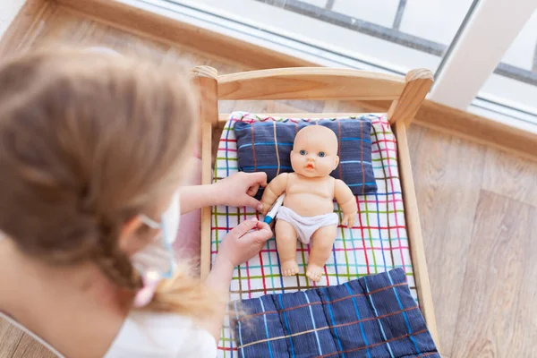 Little Girl Treats Doll Child Plays Doctor Room White Wall — Stock Photo, Image