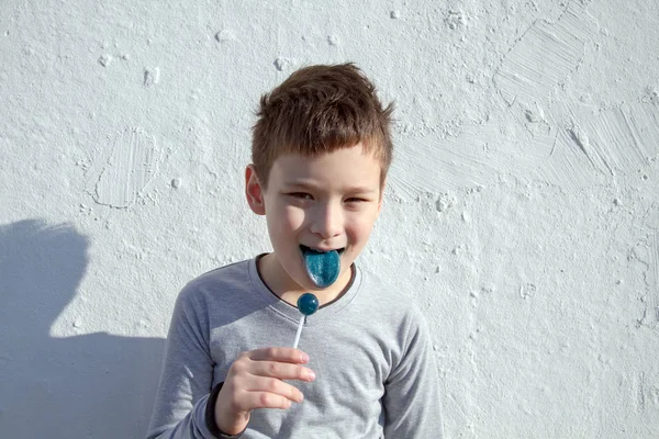 Мальчик с голубым леденцом — стоковое фото