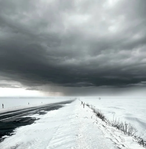 Burzliwe niebo i śnieżna droga — Zdjęcie stockowe