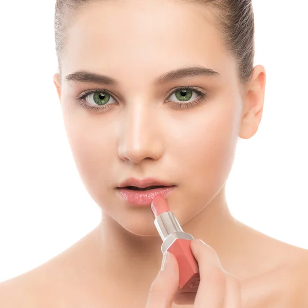 Young brunette woman with perfect clean face applying lipstick. Isolated on a white. — Stock Photo, Image